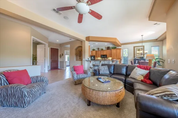 a living room with furniture and a chandelier