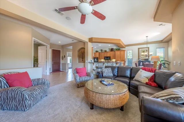 a living room with furniture and a chandelier
