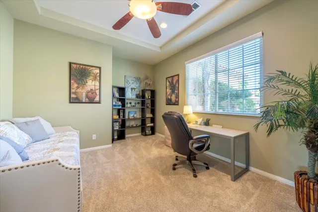 a view of a livingroom with workspace and a window
