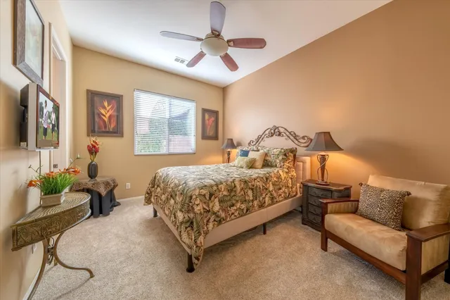 a bedroom with a bed couch and window