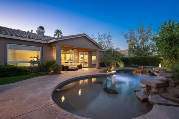 a view of a swimming pool with outdoor seating