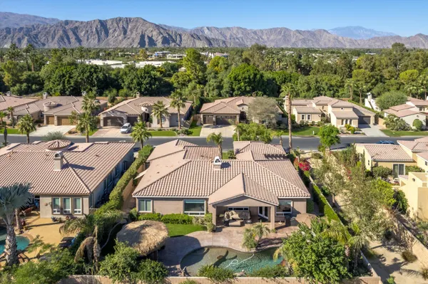an aerial view of multiple houses with a yard