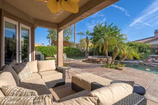 a view of swimming pool with outdoor seating and patio