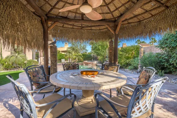 a view of a patio with a table and chairs and potted plants