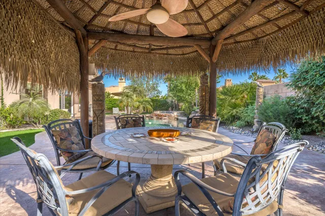 a view of a patio with a table and chairs and potted plants