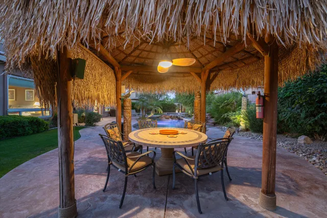 a view of a table and chairs in patio with a yard