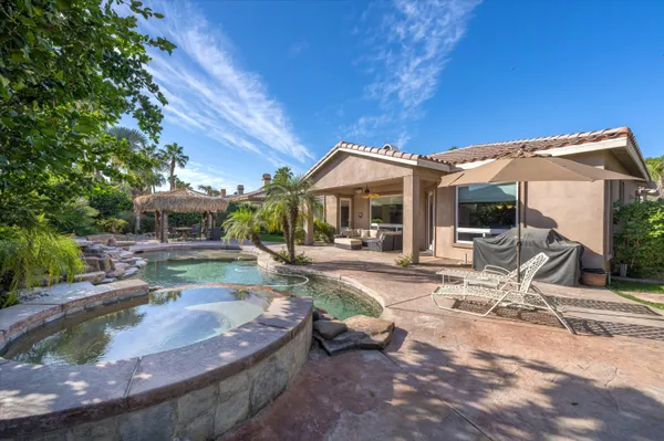 a view of a house with backyard porch and sitting area