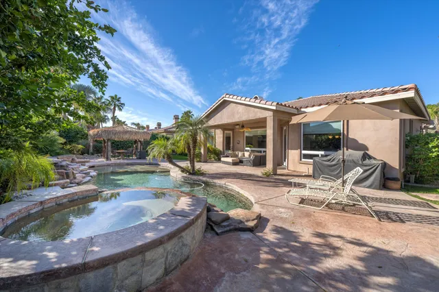 a view of a house with backyard porch and sitting area