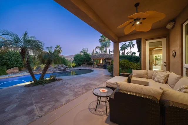 a living room with furniture a window and a flat screen tv