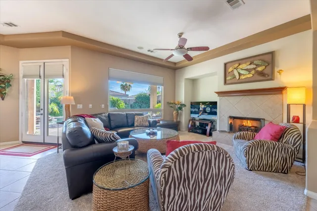a living room with furniture a fireplace and a flat screen tv