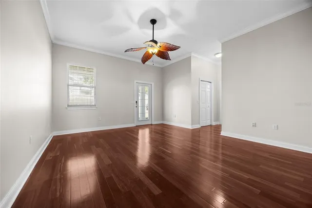 wooden floor in an empty room with a window
