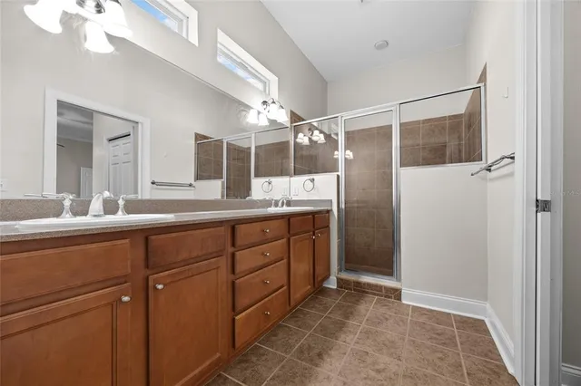 a bathroom with a shower sink and mirror