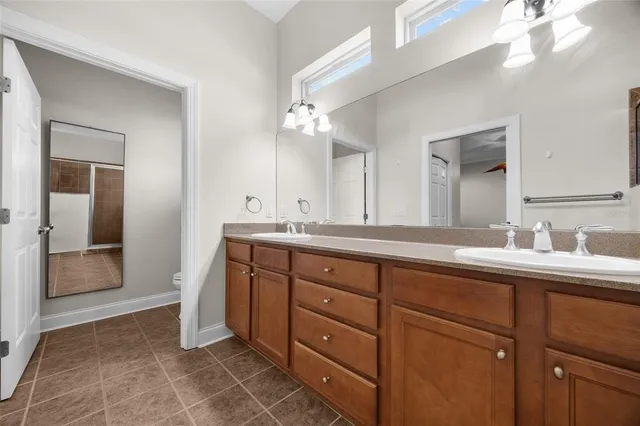 a spacious bathroom with a double vanity sink and a mirror