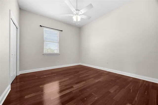 wooden floor in an empty room with a window