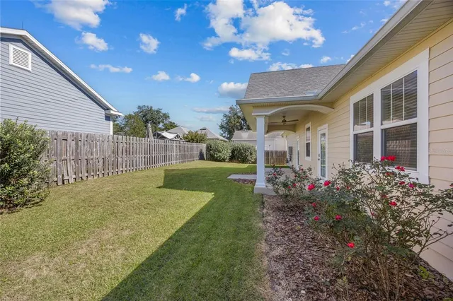 a view of a house with a big yard and potted plants