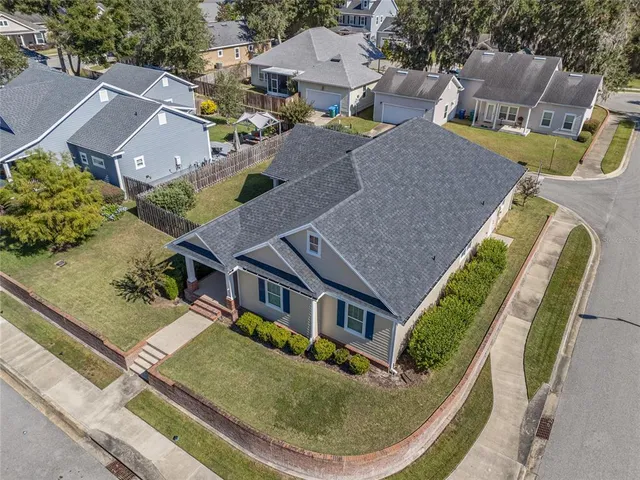 an aerial view of a house with swimming pool and glass windows