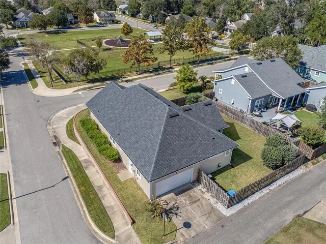 an aerial view of a house with a yard basket ball court and outdoor seating