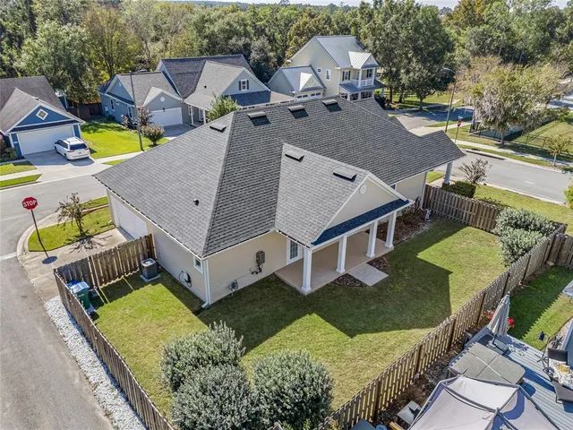 a view of a house with backyard and sitting area