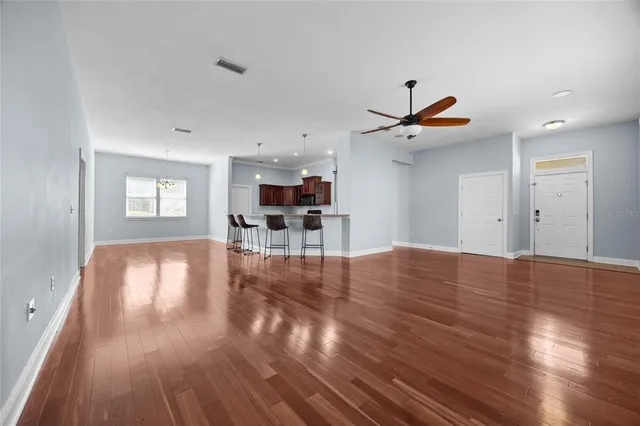 a view of a livingroom with a flat screen tv and wooden floor