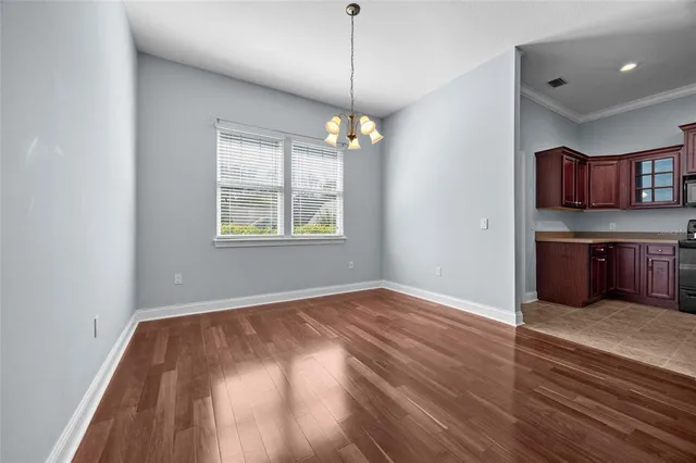 a view of a room with window and wooden floor