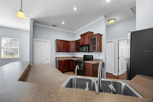 a kitchen that has a sink and a stove in it