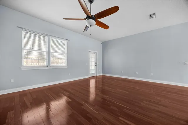 wooden floor in an empty room with a window