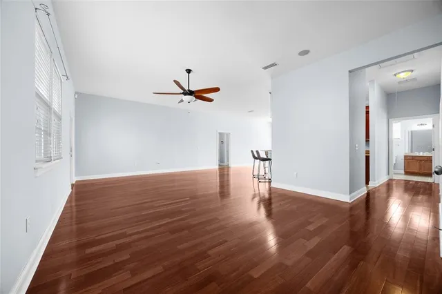 a view of empty room with wooden floor