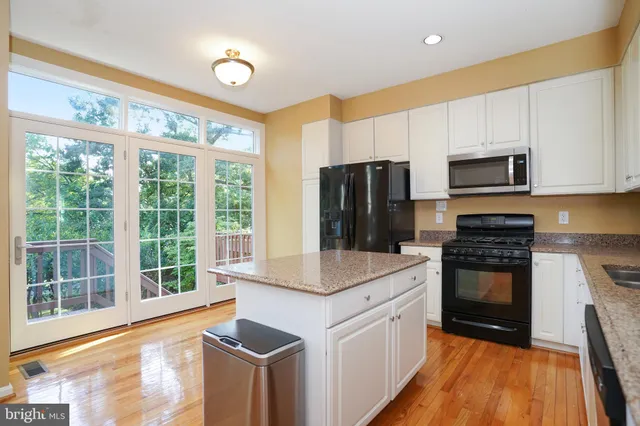 a kitchen with a stove a sink and a refrigerator