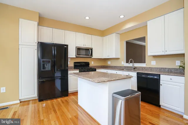 a kitchen with a refrigerator sink and microwave
