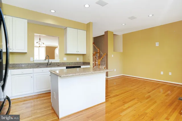 a kitchen with granite countertop a sink and cabinets