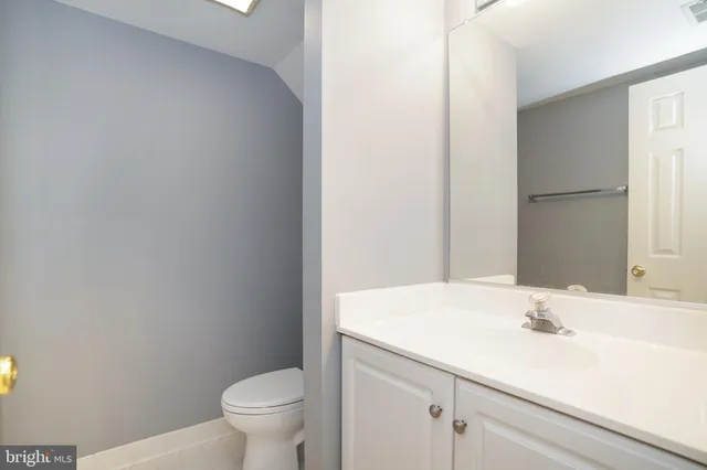 a bathroom with a sink toilet and a mirror