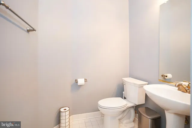 a white toilet sitting next to a white sink