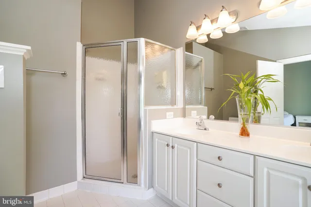 a bathroom with a sink vanity granite and a mirror
