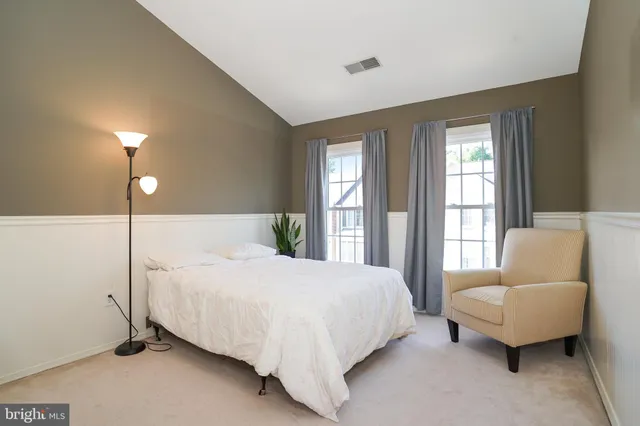 a bedroom with a bed and a couch