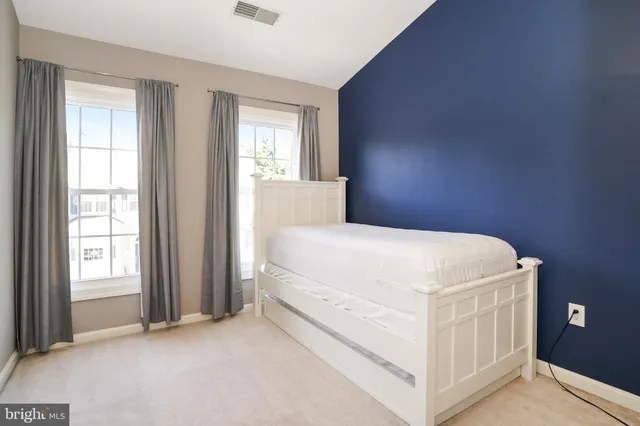 a bed room with a bed and a window