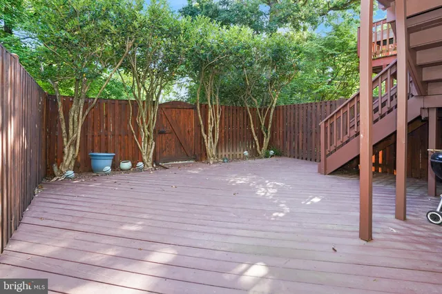a wooden fence with trees in the background