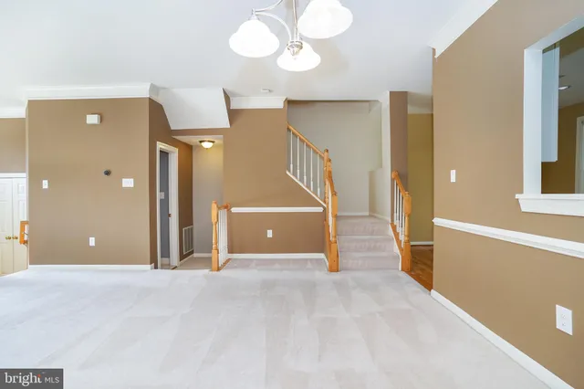 a view of a room with wooden floor and stairs