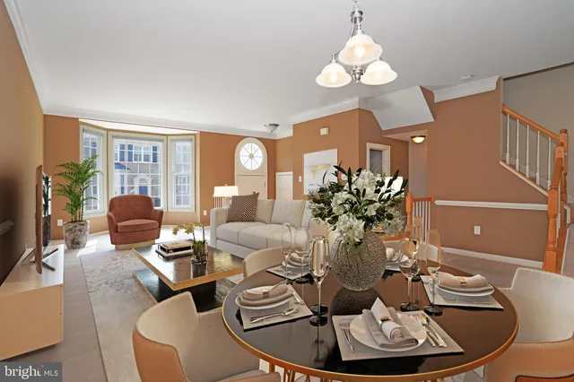 a living room with furniture chandelier and a window