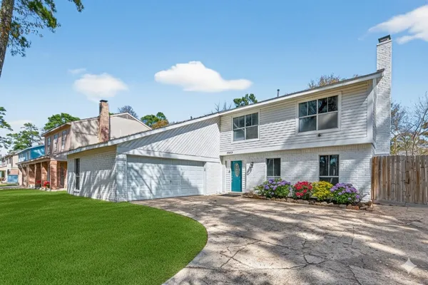 a front view of a house with white wall
