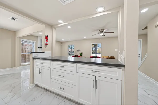 a view of a room with a table and a fireplace