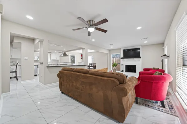 a large kitchen with kitchen island a table and chairs in it
