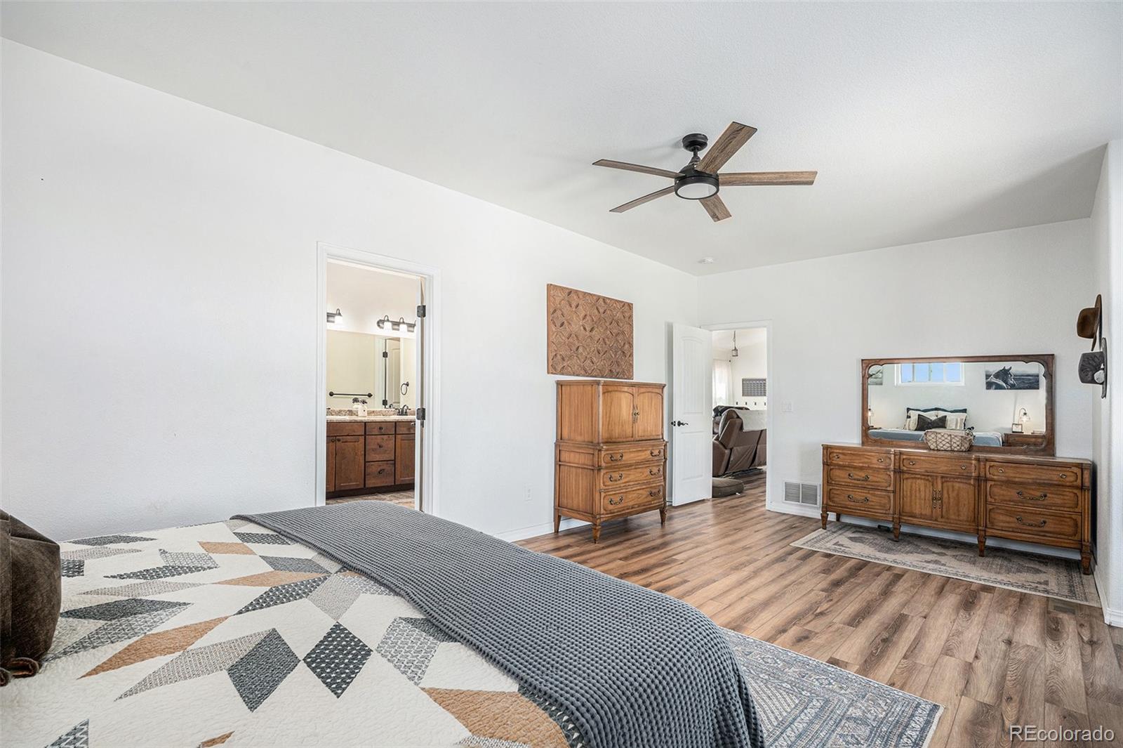 16690 Rabbit Track Trail Colorado Springs, CO 80930 - Photo 11 of 25 a bedroom with a bed and wooden floor