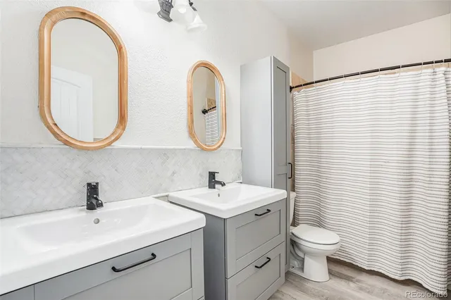 a view of a room with wooden floor and ceiling fan
