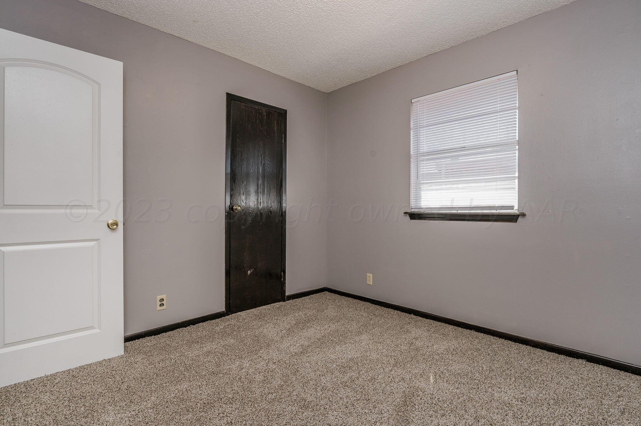 1909 Howard Drive Amarillo, TX 79106 - Photo 15 of 19 an empty room with windows and closet