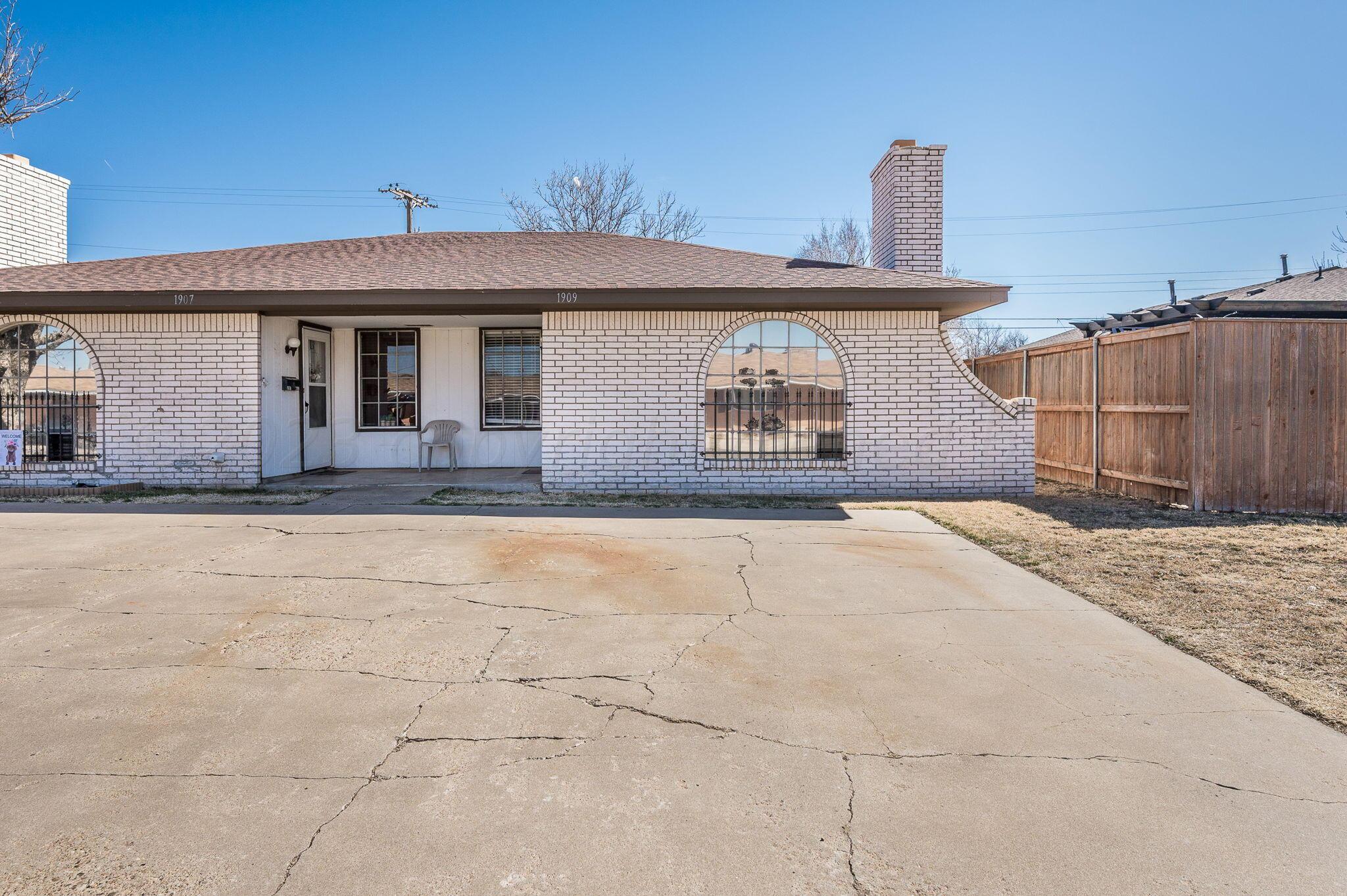 1909 Howard Drive Amarillo, TX 79106 - Photo 2 of 19 a front view of a house with a yard and garage