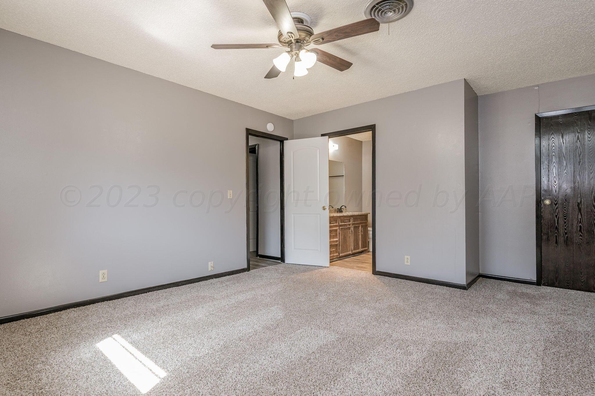 1909 Howard Drive Amarillo, TX 79106 - Photo 10 of 19 a view of a room with a ceiling fan and closet area