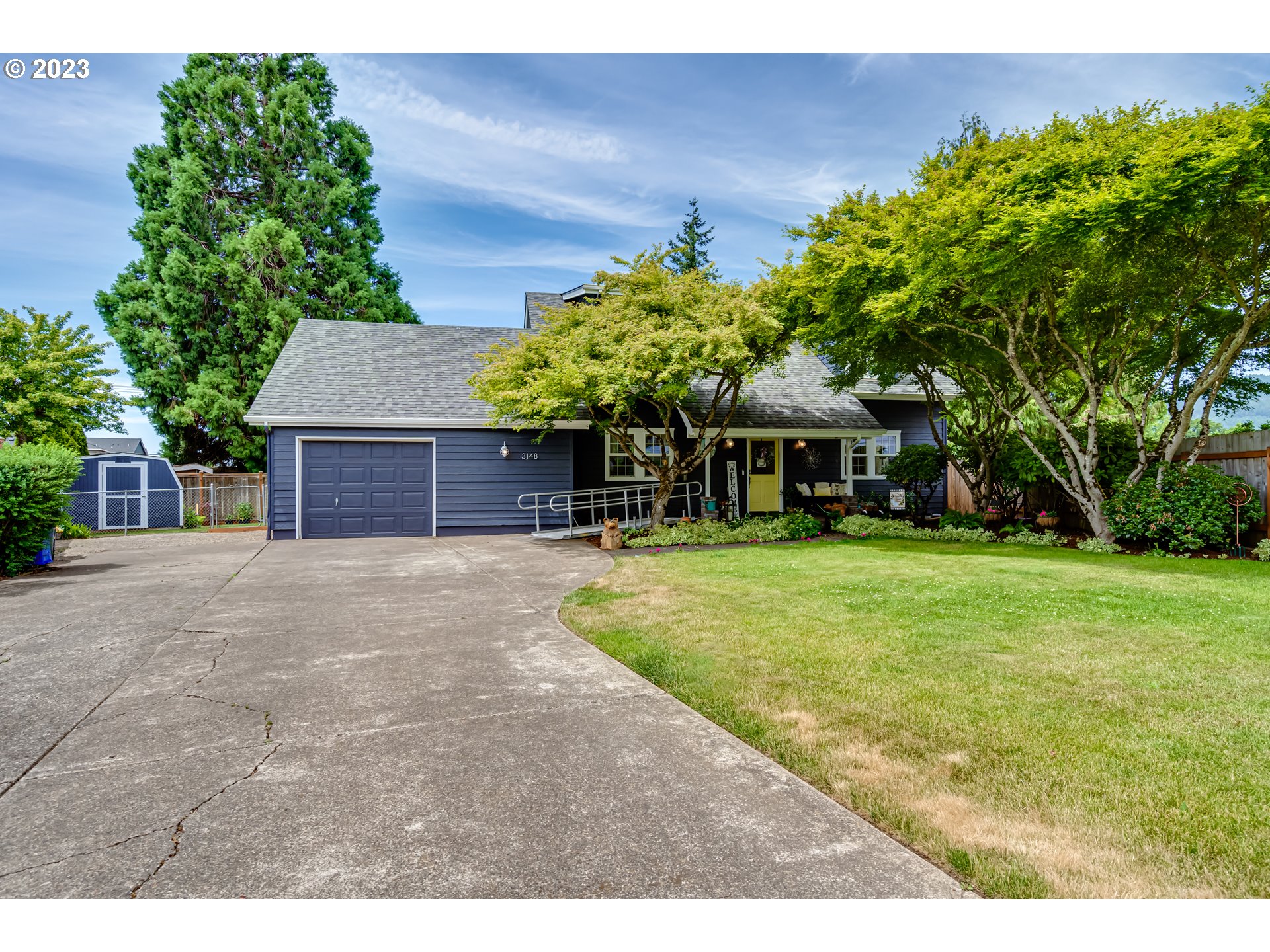 3148 W Street Springfield, OR 97477 - Photo 1 of 34 a front view of a house with a yard and garage