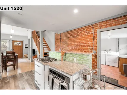a kitchen that has a table chairs in it and wooden floor