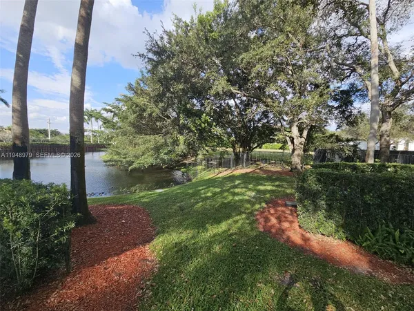 a yard with a house in back