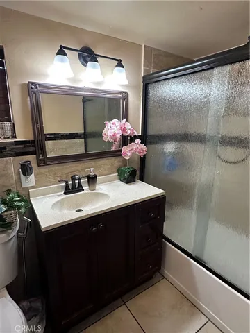 a bathroom with a sink mirror and a shower